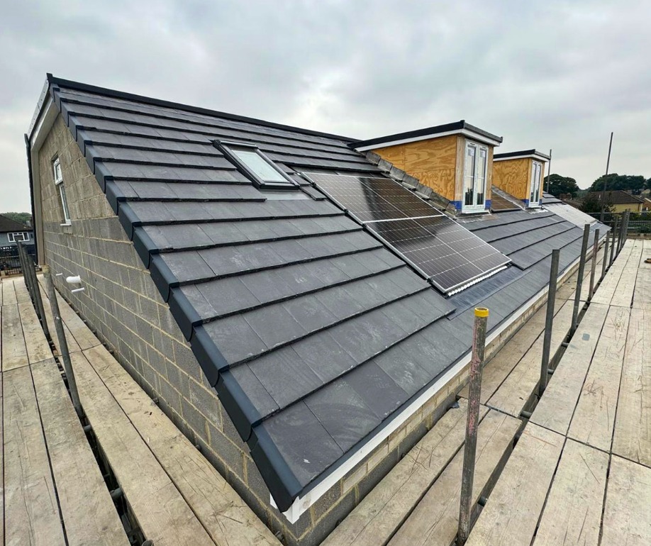 Roof with solar panels and dormers